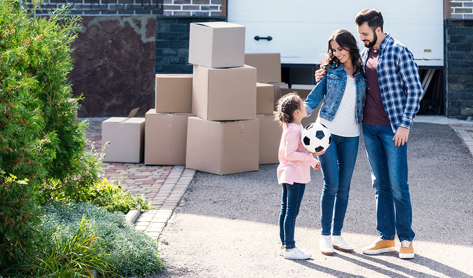 Young family unpacking moving boxes in their first home in Ottawa